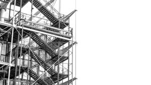 Multi-level scaffolding with intersecting stairs and beams, evoking structured workflows and support systems